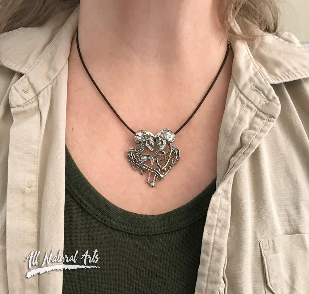 Girl wearing the Enternal Embrace necklace of a pair of skeletons entwined, By Sue Beatrice