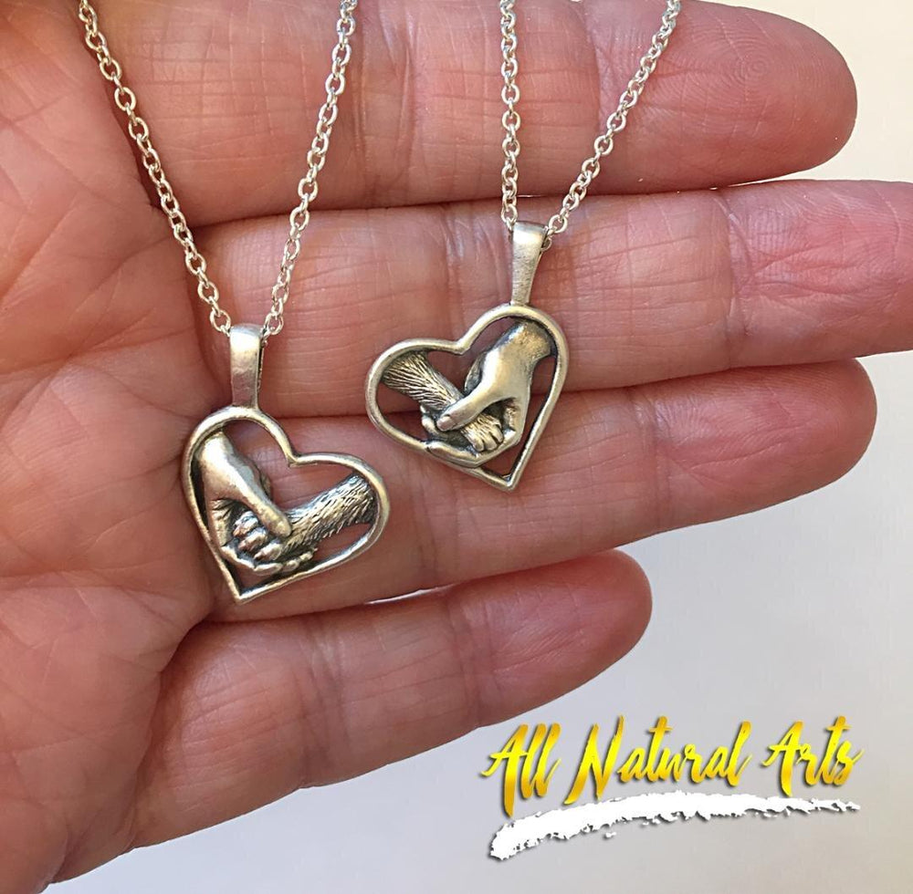 In hand - Paw Love Pup and kitty necklaces | Heart pendant with human hand and dog's paw.