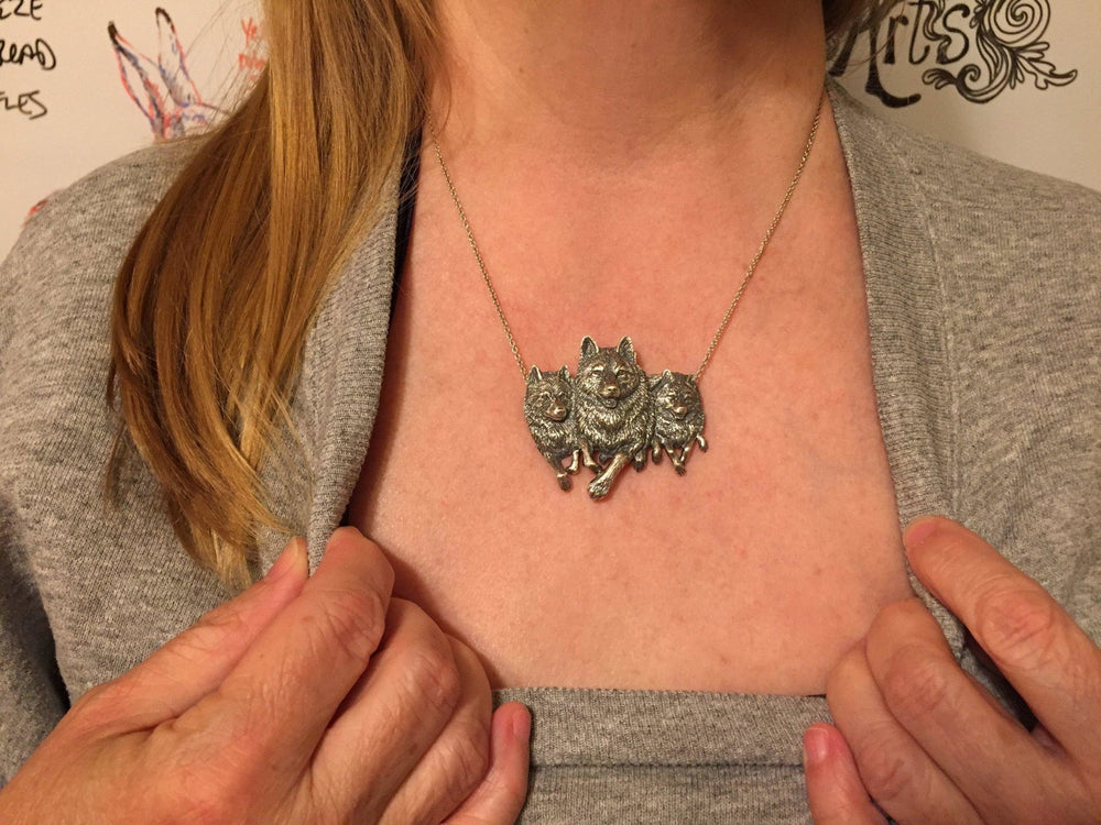 Girl wearing Running Wolves necklace: Handcrafted in Bronze | Sue Beatrice