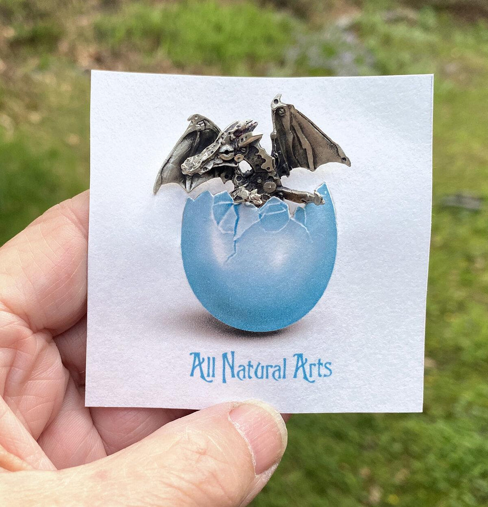 Adorable Silver Finger Dragon on display card hatching from its egg.