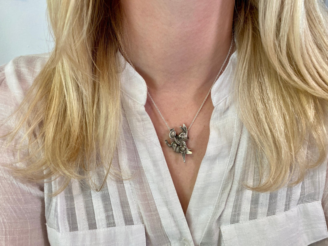 Girl in white wearing The White Rabbit pendant by Sue Beatrice.