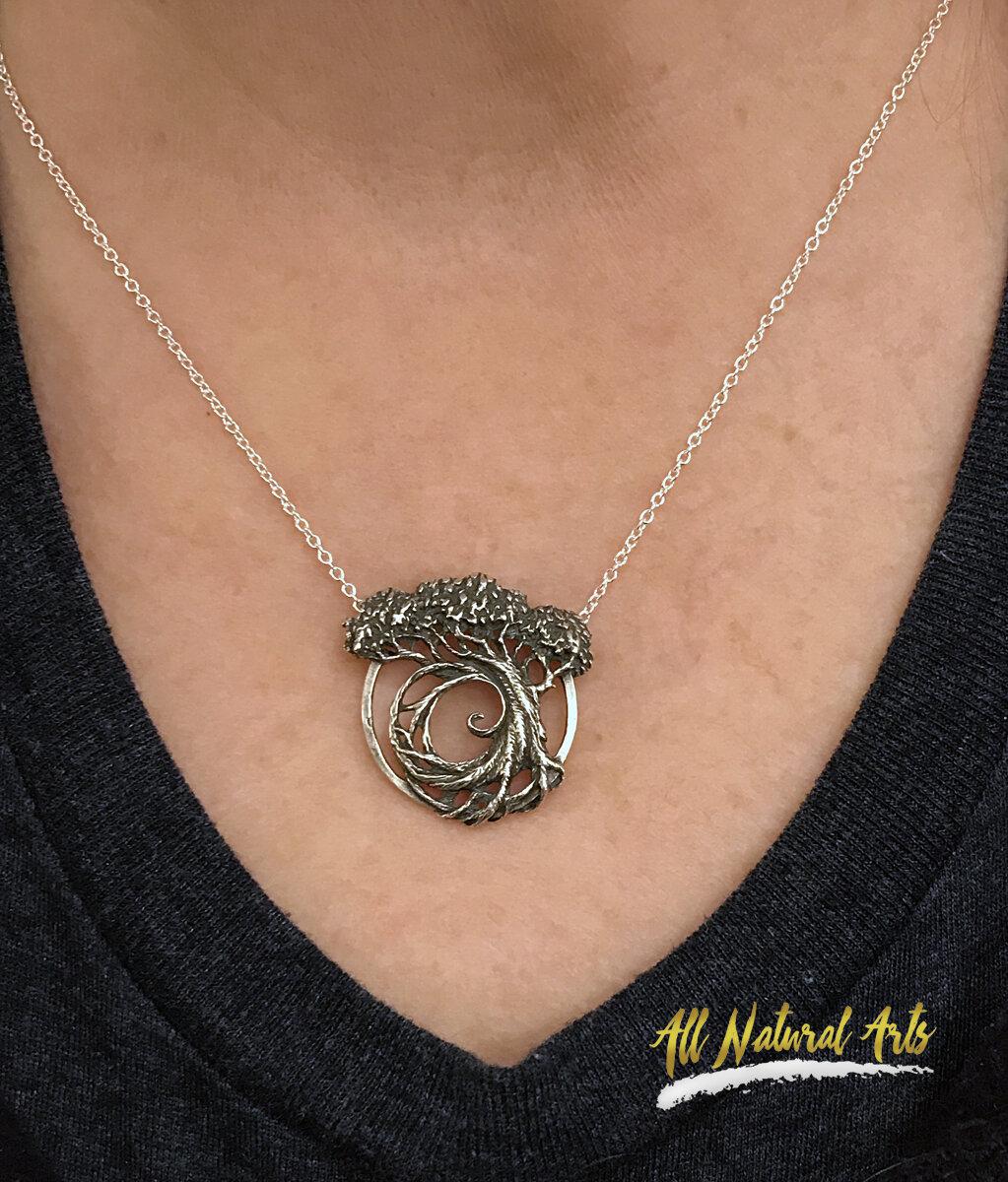 Girl wearing Sue Beatrice's Tree of Life pendant with Fibonacci Spiral on a silver chain.
