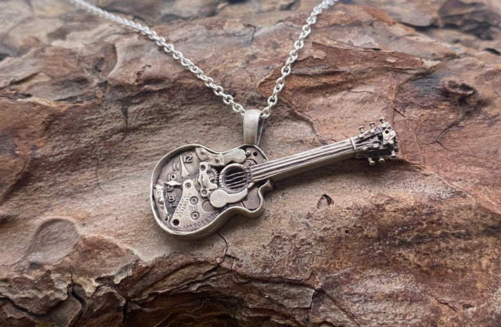 Watch parts guitar pendant cast in sterling silver on a sterling silver chain.
