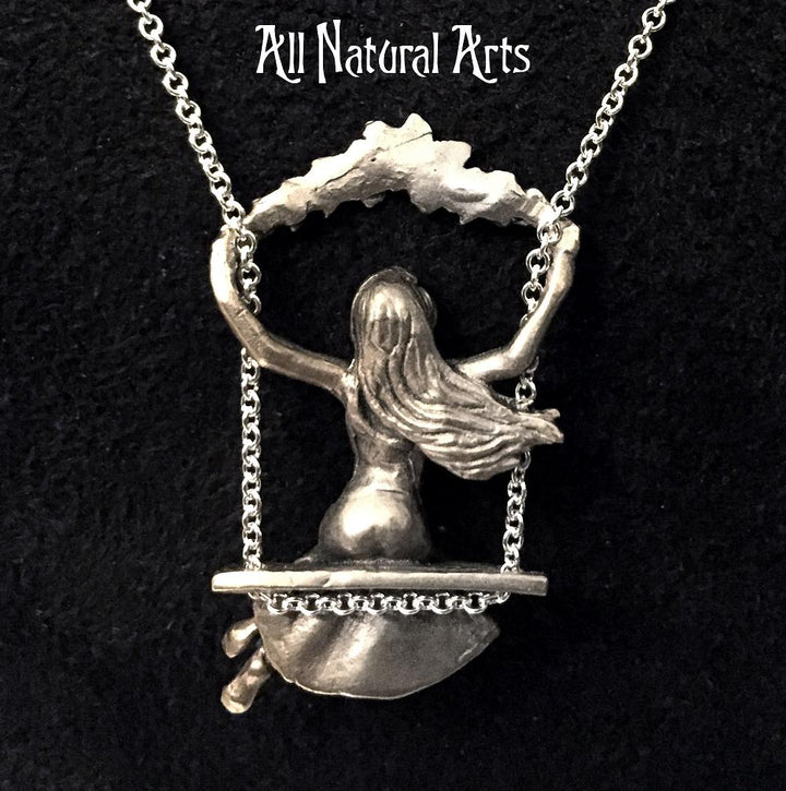 Photo showing the back of girl on the swing pendant fully carved you can see the girls hair swaying as she swings