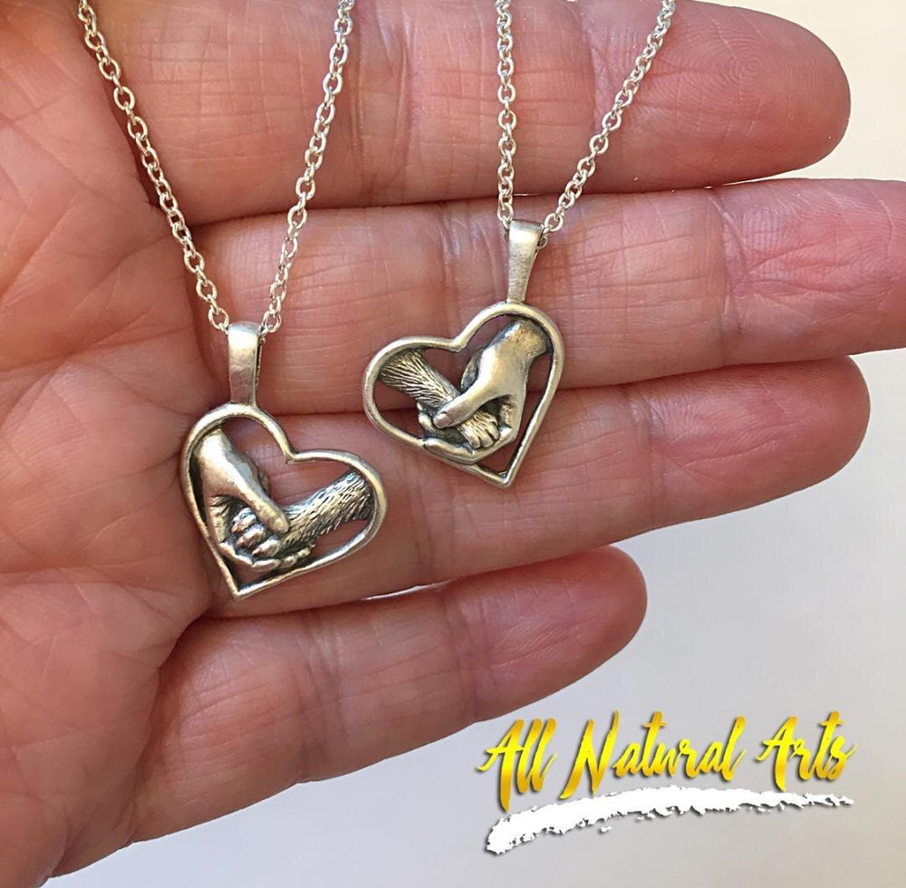 In hand - Paw Love Pup and kitty necklaces | Heart pendant with human hand and dog's paw. 