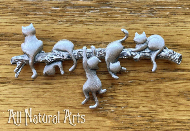 An endearing silver necklace with 5 playful cats on a branch.