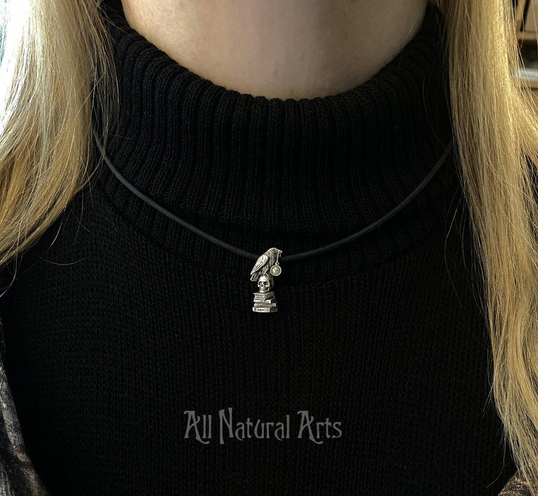 Delicate Raven pendant inspired by Edgar Allan Poe - literary jewelry by Sue Beatrice. Sterling silver necklace on black cord. 