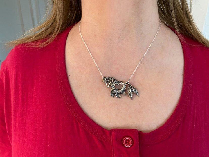 Girl wearing Sea Dragon Mermaid Necklace: Hand Carved Silver Pendant by Sue Beatrice