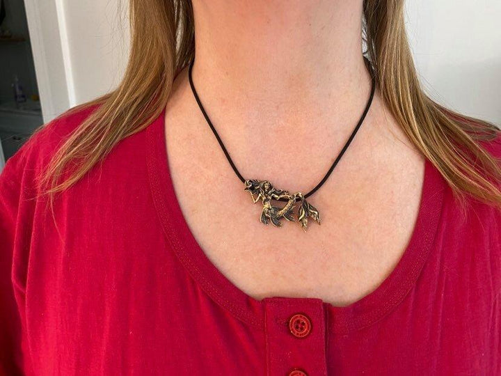 Girl wearing Sea Dragon Mermaid Necklace: Hand Carved Bronze Pendant by Sue Beatrice