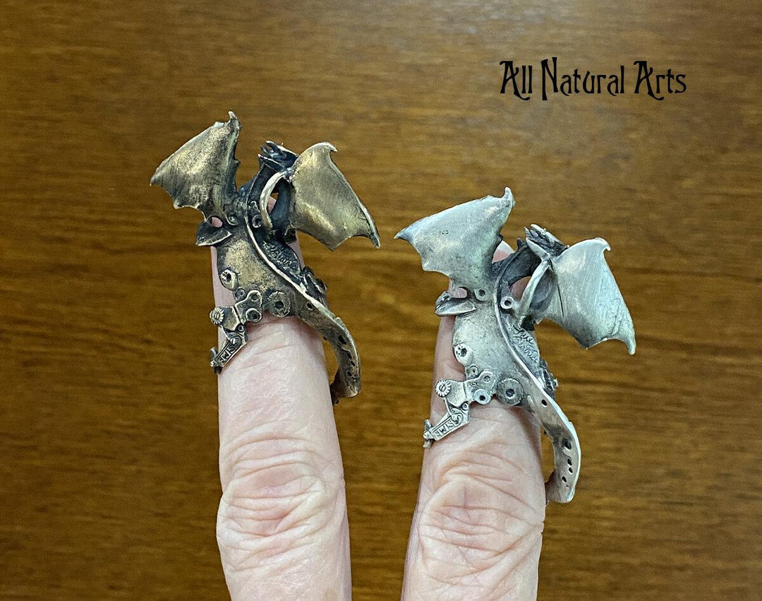 The backs of Silver and Bronze Finger Dragons perched on a fingers.