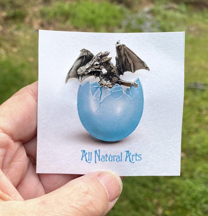 Adorable Silver Finger Dragon on display card hatching from its egg. 