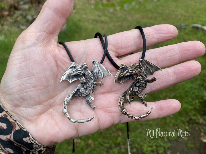 Silver and Bronze Finger Dragons held in hand. 