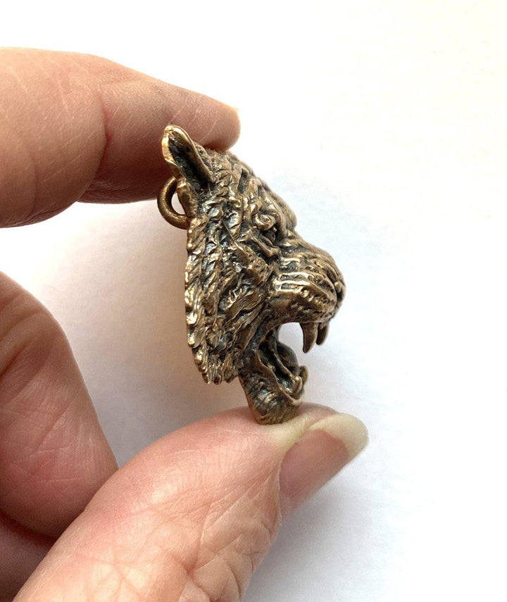 Side view of Realistic Tiger Pendant in hand. 