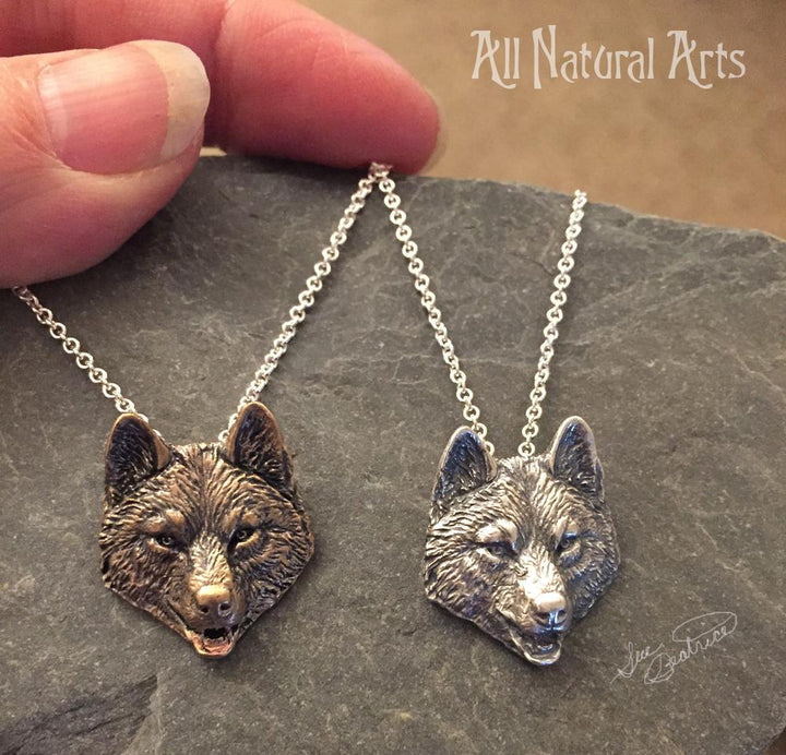 Sterling Silver and Bronze Detailed Wolf Head Pendant Necklaces on silver chains.